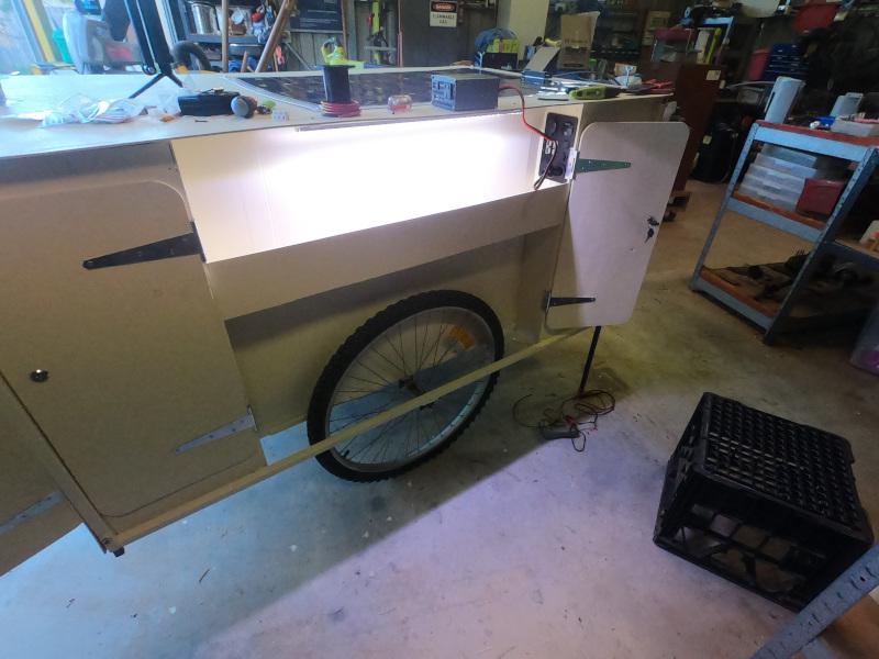 Another photo of the trailer, this time showing the corner cabinets and built-in lighting for use when camping or similar.
